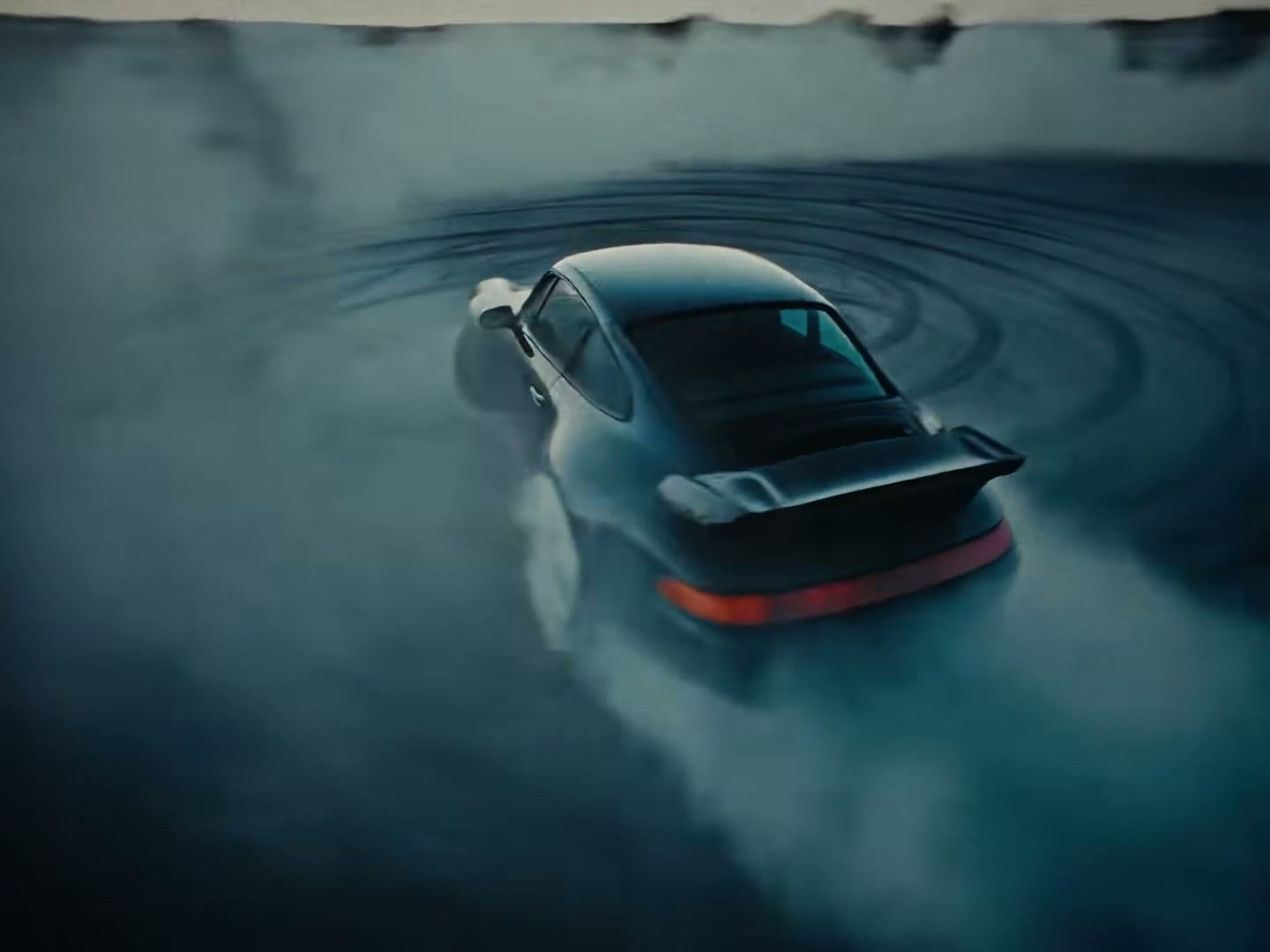 A drifting car surrounded by smoke in Eladio Carrión's Ricky Bobby
