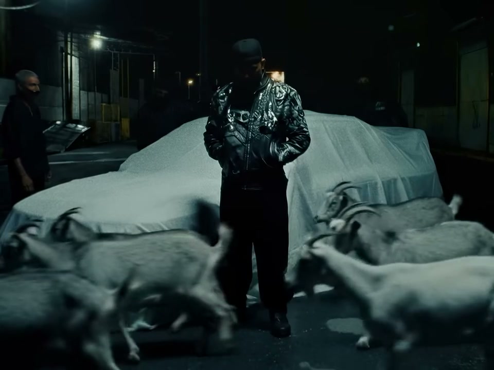 AI-generated goats crossing in front of Eladio Carrión in De Chamaquito